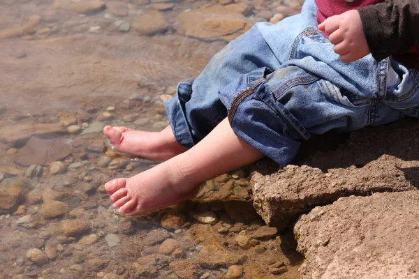 Baby with its fit in the water