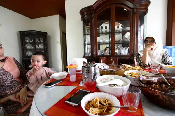 Family sitting around the dinner table eating